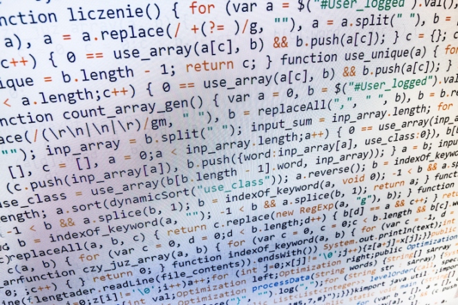 Software developer programming code on computer